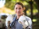 Kim Clavel, boxer and nurse, has been featured in Time magazine's Next Generation Leaders, a biannual selection of rising stars in politics, technology, culture, science, sports, and business.  Carnation in gloves and gown in front of her home in Montreal on Sunday, October 11, 2020.