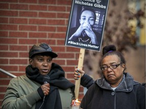 Erma Gibbs, mother of Nicholas Gibbs, listens as her daughter Tricia speaks at a vigil outside the Montreal Police Brotherhood office in Montreal on October 22, 2018, for families of people who have been killed by police.