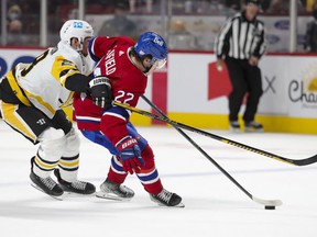 Cole Caufield of the Montreal Canadiens stops Marcus Pettersson of the Pittsburgh Penguins during the third period in Montreal on Thursday, Nov. 18, 2021.