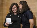 Nathalie Provost, a survivor of the Polytechnique massacre, kisses Édith Ducharme, this year's winner of the $ 30,000 scholarship from the Order of the White Rose.