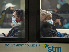 Masked subway passengers at the Guy-Concordia subway stop in Montreal on Friday, December 10, 2021.
