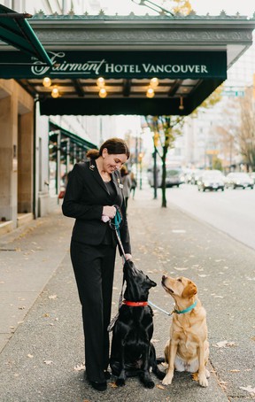 Concierge Debbie Wild with Elly and Ella, the Fairmont Hotel Vancouver canine ambassadors.