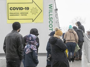 People wait in line at the COVID testing clinic at the Jewish General Hospital on Wednesday, December 22, 2021.