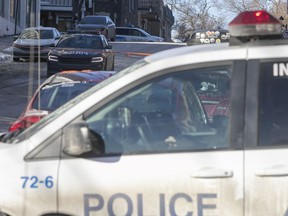 Montreal police cars parked near the crime scene on des Érables Ave., where the 35th homicide of the year occurred Wednesday night.