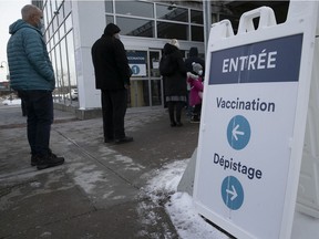 People line up for vaccinations at the St-Laurent COVID-19 vaccination center on Ste-Croix Blvd. on Mondays.