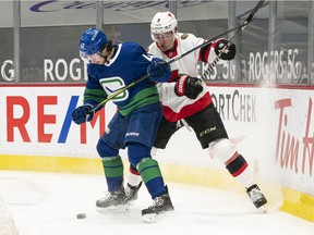 Quinn Hughes (left) and Josh Norris, who battled for the puck during a Rogers Arena game last season, have been good friends since joining the US National Development Team Program in the 2015-16 season. .