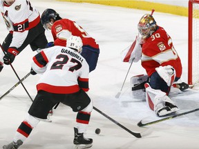 Florida Panthers goalie Spencer Knight # 30 defends the net against a shot by Ottawa Senators' Dylan Gambrell # 27 during the first period.