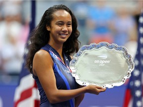 Leylah Annie Fernandez de Laval celebrates with the runner-up trophy after being defeated by Emma Raducanu of Great Britain at the US Open in Flushing NY on September 11, 2021.
