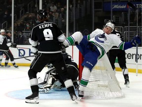 Matthew Highmore of the Vancouver Canucks collides with Adrian Kempe of the Los Angeles Kings during first period at Crypto.com Arena on December 30, 2021 in Los Angeles, California.