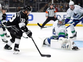 Viktor Arvidsson of the Los Angeles Kings shoots the puck against Jaroslav Halak of the Vancouver Canucks during the second period at Crypto.com Arena on December 30, 2021 in Los Angeles, California.
