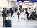 Travelers head to check-in for their flights departing from Montreal's Pierre-Elliott Trudeau International Airport, Monday, Nov. 29, 2021.