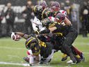 Hamilton Tiger-Cats running back Don Jackson (5) throws himself across the goal line while scoring a touchdown during the first half of CFL division semifinal football action against the Montreal Alouettes in Hamilton, Ontario , on Sunday, November 28, 2021.