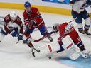 Andre Burakovsky (95) of Colorado Avalanche shoots a puck past Montreal Canadiens goalkeeper Jake Allen, while Cole Caufield (22) tries to create interference during NHL third-period action in Montreal on Thursday, December 2. of 2021. 
