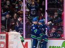 Elias Pettersson of the Vancouver Canucks, left, of Sweden and Conor Garland celebrate Garland's goal against the Los Angeles Kings during the second period of NHL hockey action in Vancouver, BC on Monday, December 6, 2021 .