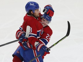 Cole Caufield (22) of the Montreal Canadiens celebrates the goal of teammate Ben Chiarot (8) during the second period in Montreal on Thursday, December 2, 2021.