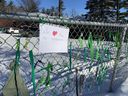 Students and parents posted ribbons and a sign on a fence by the Chelsea Elementary School teacher to show their support for a teacher who was removed from her post because she wears a hijab.