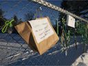 Signs and tapes are seen on a fence outside an elementary school protesting Quebec Bill 21 and the absence of a teacher, Thursday, Dec. 9, 2021, in Chelsea, Quebec.