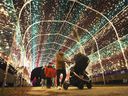 People enjoy the views at the Bright Lights Windsor exhibit in Jackson Park on Thursday, Dec. 2, 2021.