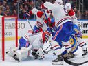 Canadiens goalkeeper Jake Allen saves in a scrum against the Blues during the third period at the Enterprise Center on Saturday, Dec. 11, 2021, in St Louis.