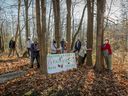 Members of Save the Fairview Forest gather in the wooded area west of the Fairview Pointe-Claire Mall on November 10, 2020. Two new councilors and Mayor-elect Tim Thomas championed the group's cause during the recent election campaign.