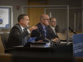 Chief Financial Officer Joe Mancina, left, and Managing Director Jason Reynar, far right, join Mayor Drew Dilkens in a press conference to outline the 2022 municipal budget framework at City Hall, Friday, 19 November 2021.