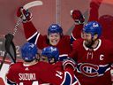 Cole Caufield of Montreal Canadiens, center, celebrates with Nick Suzuki, Brendan Gallagher and Shea Weber, right, after defeating the Vegas Golden Knights in Game 6 to advance to the Stanley Cup final in Montreal on 24 June 2021.