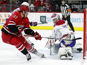 Canadiens goalkeeper Sam Montembeault deflects Hurricanes' Andrei Svechnikov's shot during the second period Thursday night in Raleigh, NC