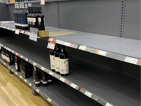 Shelves at Atwater SAQ are nearly empty as a result of a labor dispute with warehouse workers in Montreal on Tuesday, Nov.30, 2021.
