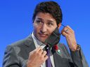 Prime Minister Justin Trudeau removes his mask during the United Nations Climate Change Conference (COP26) in Glasgow, Scotland, Great Britain, on November 2, 2021.