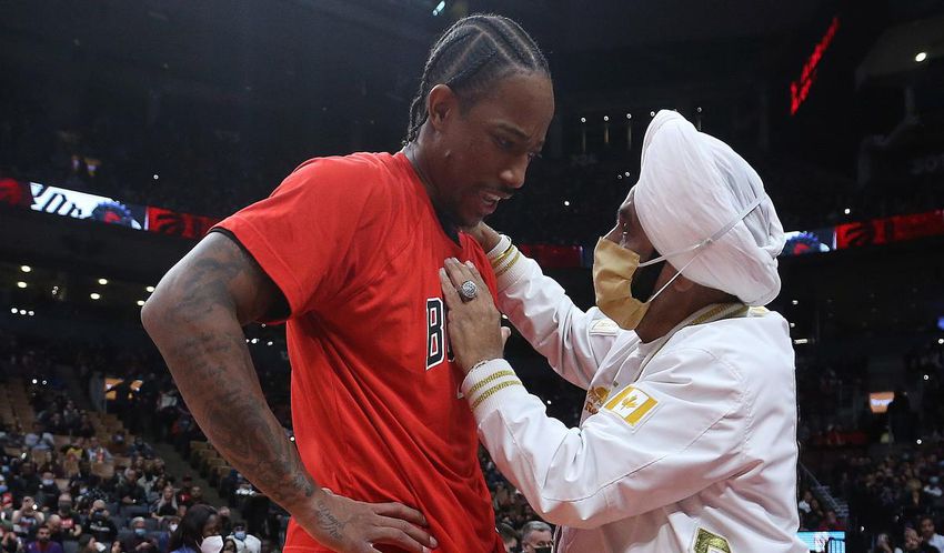 Chicago forward DeMar DeRozan (left) talks to Raptors Superfan Nav Bhatia before the game against the Bulls in October.