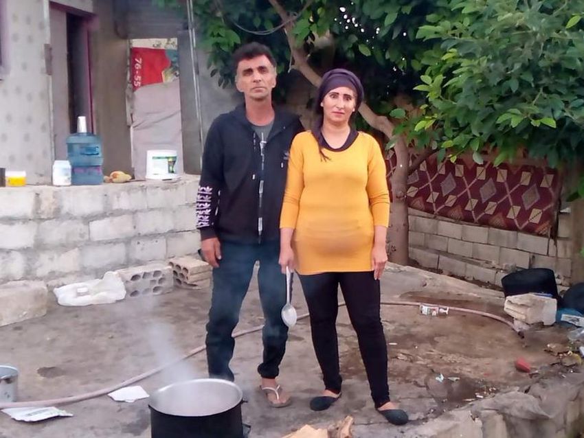 Sanam and her husband Othman cook dinner in their backyard kitchen for their eight children in Lebanon.
