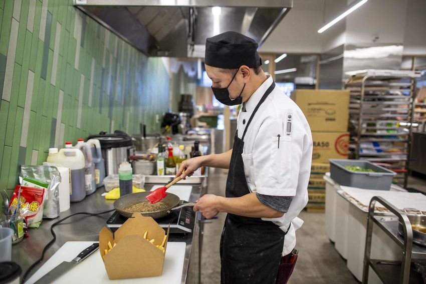 Chef DH Cho prepares Taiwanese poutine in the kitchen at the Maeli Market.  The takeout menu is a mix of Taiwanese options and more modern interpretations of the cuisine.