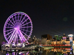 The Ferris wheel in Montreal is seen on April 4, 2020, in the Old Port tourist district, and illuminated with the colors of the rainbow in support of the victims of the COVID-19 pandemic.