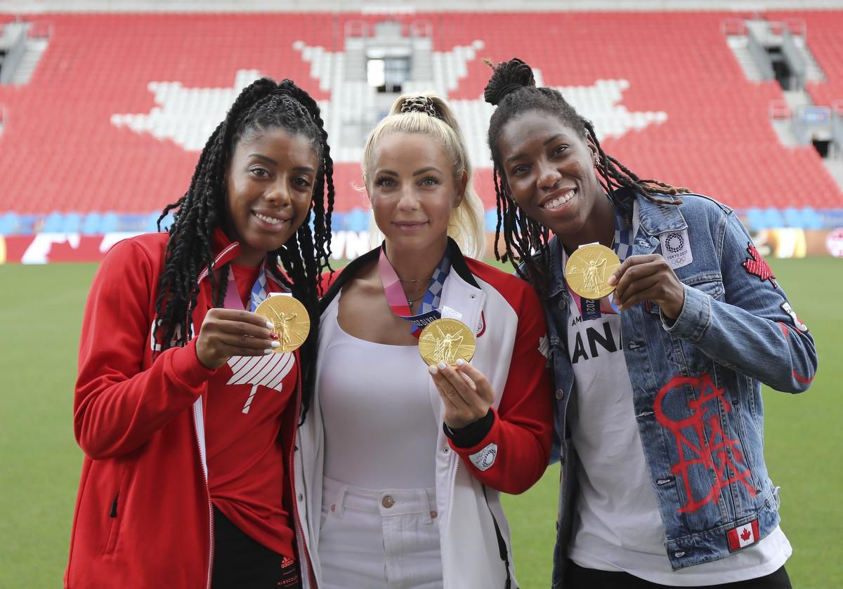 Ashley Lawrence (left), seen here with teammates Adriana Leon and Kadeisha Buchanan, helped Canada take home a gold medal at the Tokyo Olympics in August.