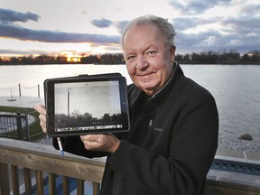 Ron Renaud from Amherstburg shows a picture of the tower on Boblo Island, in view of where the tower used to be located before it was demolished.  Photographed December 2, 2021.