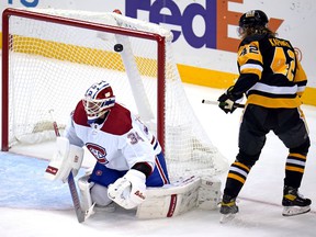 The Penguins' Kasperi Kapanen hits the puck over Canadiens goalkeeper Jake Allen for the first goal of the game Tuesday night in Pittsburgh.
