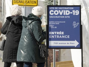 People enter a COVID-19 vaccination site on Wednesday, December 1, 2021 in Montreal.