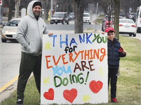Frontline healthcare workers have faced harassment, threats and worse.  But there have also been many open demonstrations of support for their pandemic work, including by this father and son showing off the Met campus of Windsor Regional Hospital on March 27, 2020.