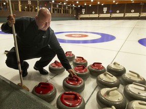 Dave Deluzio, General Manager and Golf Pro at Roseland Golf and Curling Club, places curling stones on the ice, Wednesday, Dec. 8, 2021.