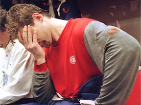 Shayne Corson covers his face in the Canadiens' locker room after losing 3-1 to the Buffalo Sabers on May 14, 1998. Dave Sidaway / Montreal Gazette