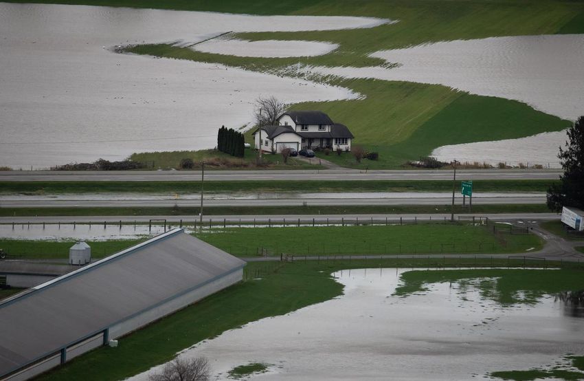 A home sits on high ground among flooded farmland in Abbotsford, BC, on Wednesday.