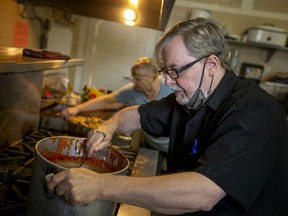 Roger Fordham prepares food at New Song Church, Thursday, December 2, 2021. According to Feed Ontario, demand for food banks has reached record levels in Ontario.
