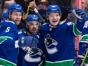 Canucks winger Vasily Podkolzin (right) has had a lot to smile about during his rookie season in the NHL.