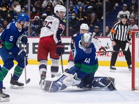 Canucks defender Tucker Poolman (left) in first period action against the Columbus Blue Jackets at Rogers Arena on Tuesday.
