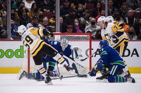 Pittsburgh Penguins Jake Guentzel scores his third goal of the night against Vancouver Canucks goalkeeper Thatcher Demko on Saturday at Rogers Arena.