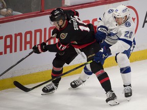 Ottawa Senators left wing Tim Stuetzle (18) and Tampa Bay Lightning center Riley Nash (20) battle it out in the third period at the Canadian Tire Center.