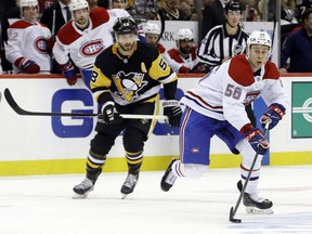Canadiens' Jesse Ylönen moves the puck past Penguins defender Kris Letang during the third period in Pittsburgh on Tuesday night.  Ylönen scored his first NHL goal in the second period during Montreal's 5-2 loss.