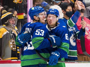 Brock Boeser (right) giving captain Bo Horvat a hug after the Canucks' victory in the Dec. 8 shootout over Boston, has been shooting and scoring more often in all six games under new coach Bruce Boudreau.