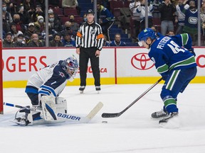 Vancouver Canucks forward Elias Pettersson scores on Winnipeg Jets goalkeeper Eric Comrie during the shootout at Rogers Arena on Friday.  Vancouver won 4-3 in a shootout.