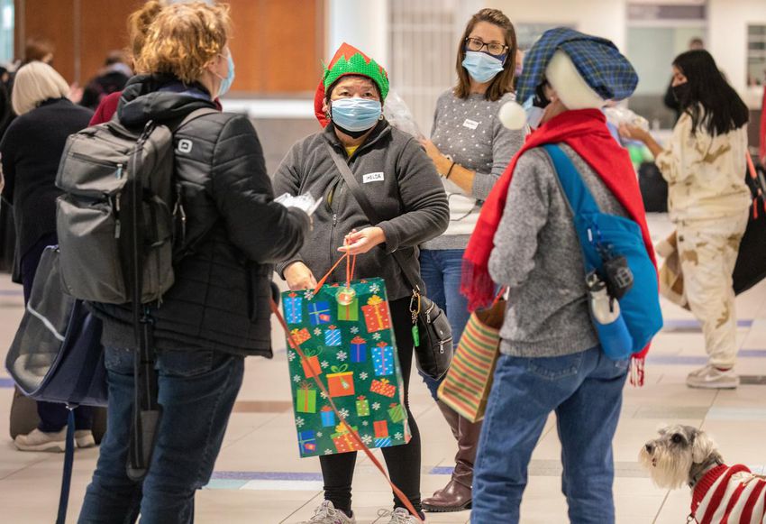 Volunteer Imelda Montinola introduces travelers arriving at Halifax Stanfield International Airport with rapid COVID-19 tests.